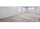 Large bedroom with plush carpet, two bright windows, and neutral paint at 517 Elkwood Ln, Mcdonough, GA 30253