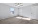 This bedroom has plush neutral carpet, a ceiling fan, and a closet for storage at 517 Elkwood Ln, Mcdonough, GA 30253