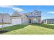 Charming two-story home with well-manicured lawn, attached two-car garage and inviting curb appeal at 517 Elkwood Ln, Mcdonough, GA 30253