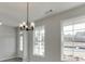 Dining room features an elegant chandelier and large windows at 2554 Hickory Valley Dr, Snellville, GA 30078