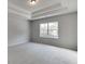 This is a cozy bedroom with gray walls, carpeted floor, and a window that lets in natural light at 2594 Hickory Valley Dr, Snellville, GA 30078