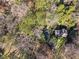Aerial perspective highlights the property nestled within a lush, wooded area offering privacy at 3200 Wood Valley Nw Rd, Atlanta, GA 30327
