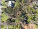 An aerial view of the property, highlighting the home's setting among lush trees and landscaping at 3200 Wood Valley Nw Rd, Atlanta, GA 30327