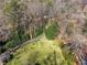 Aerial view of a large lot with mature trees, a winding driveway, and a spacious lawn at 3200 Wood Valley Nw Rd, Atlanta, GA 30327
