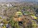 An aerial view showcasing the property surrounded by lush greenery, with manicured lawns and mature trees at 3200 Wood Valley Nw Rd, Atlanta, GA 30327