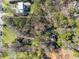 Expansive aerial shot revealing a sprawling lot bordered by mature trees and other large properties at 3200 Wood Valley Nw Rd, Atlanta, GA 30327