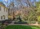 The backyard features a lush landscaped area with a brick walkway and manicured lawn, perfect for outdoor relaxation at 3200 Wood Valley Nw Rd, Atlanta, GA 30327