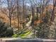 Backyard boasts beautiful trees and lush greenery and stone pathways leading to the house at 3200 Wood Valley Nw Rd, Atlanta, GA 30327
