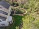 Aerial view highlighting the backyard's brick pathway with landscaping, set next to the house exterior at 3200 Wood Valley Nw Rd, Atlanta, GA 30327