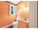 Charming powder room with a patterned wallpaper, window, and vanity at 3200 Wood Valley Nw Rd, Atlanta, GA 30327