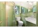 Bathroom featuring green tile, glass shower and a window with green shutters at 3200 Wood Valley Nw Rd, Atlanta, GA 30327