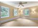Bright bedroom with carpeted floors, ceiling fan and three windows bringing in natural light at 3200 Wood Valley Nw Rd, Atlanta, GA 30327