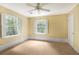 Bright bedroom with two sunny windows with outdoor views, neutral carpet, and a ceiling fan at 3200 Wood Valley Nw Rd, Atlanta, GA 30327