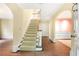 Inviting entryway featuring a staircase, hardwood floors, and arched doorways leading to other rooms at 3200 Wood Valley Nw Rd, Atlanta, GA 30327