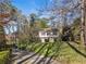 Charming two-story home featuring black shutters and a stone foundation, nestled on a well-manicured, tree-lined lot at 3200 Wood Valley Nw Rd, Atlanta, GA 30327