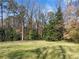 View of the front lawn with lush green grass and mature trees providing shade and privacy at 3200 Wood Valley Nw Rd, Atlanta, GA 30327
