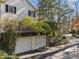Attached two-car garage beneath upper level with mature trees on an ample lot, offering convenience and privacy at 3200 Wood Valley Nw Rd, Atlanta, GA 30327