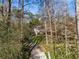 Charming house viewed from a distance down a long driveway surrounded by mature trees at 3200 Wood Valley Nw Rd, Atlanta, GA 30327