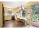 Eat-in kitchen with wood floors, white countertops, and access to the brick patio at 3200 Wood Valley Nw Rd, Atlanta, GA 30327