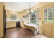 Charming kitchen with yellow cabinets, dark wood floors, and window with a build in seating area at 3200 Wood Valley Nw Rd, Atlanta, GA 30327