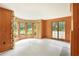 Living room with wood paneling, a large bay window, and french doors at 3200 Wood Valley Nw Rd, Atlanta, GA 30327