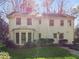 The rear exterior of this charming home has an enclosed sunroom addition and manicured lawn at 3200 Wood Valley Nw Rd, Atlanta, GA 30327