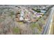 Neighborhood aerial view showcasing homes, tennis courts, and nearby roads at 1315 Thunder Gulch Pass, Suwanee, GA 30024