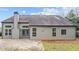 Backyard exterior showcasing the home's siding, windows, chimney, and patio at 1315 Thunder Gulch Pass, Suwanee, GA 30024