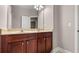 Bathroom featuring a double vanity with dark wood cabinets and a large mirror at 1315 Thunder Gulch Pass, Suwanee, GA 30024