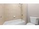 Tiled shower and tub combination with white fixtures and modern shower head at 1315 Thunder Gulch Pass, Suwanee, GA 30024