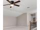 Bright bonus room featuring neutral walls, plush carpet, and a modern ceiling fan providing comfort at 1315 Thunder Gulch Pass, Suwanee, GA 30024