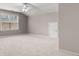 Neutral bonus room filled with natural light, featuring plush carpet and a large window at 1315 Thunder Gulch Pass, Suwanee, GA 30024
