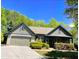 Charming single-story home with a two-car garage, stone accents, and a well-manicured front yard at 1315 Thunder Gulch Pass, Suwanee, GA 30024