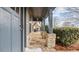 Charming front porch with stone pillars and a blue door at 1315 Thunder Gulch Pass, Suwanee, GA 30024