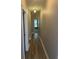 Well-lit hallway featuring hardwood floors, leading to other rooms in the home at 1315 Thunder Gulch Pass, Suwanee, GA 30024