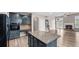 Modern kitchen with granite countertops, island, stainless steel appliances, and open layout at 1315 Thunder Gulch Pass, Suwanee, GA 30024