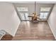 Aerial view of living room with fireplace, ceiling fan, and large windows at 1315 Thunder Gulch Pass, Suwanee, GA 30024