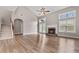 Bright living room featuring vaulted ceilings, a cozy fireplace, and gleaming hardwood floors at 1315 Thunder Gulch Pass, Suwanee, GA 30024