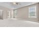 Bright main bedroom featuring natural light, neutral walls, plush carpet, and two windows for outdoor views at 1315 Thunder Gulch Pass, Suwanee, GA 30024