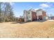 Large backyard with a sprawling lawn and a view of the rear of the house at 1574 Stepstone Way, Lawrenceville, GA 30043