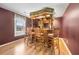 Basement bar area featuring bar seating, hardwood floors, and custom lighting at 1574 Stepstone Way, Lawrenceville, GA 30043