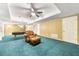 Finished basement features plush blue carpet, drop ceiling, pool table and comfortable chair with ottoman at 1574 Stepstone Way, Lawrenceville, GA 30043