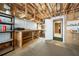 Unfinished basement space featuring open ceiling and a workbench at 1574 Stepstone Way, Lawrenceville, GA 30043