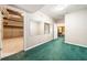 Finished basement with neutral paint, green carpet, and plenty of storage and recreational space at 1574 Stepstone Way, Lawrenceville, GA 30043