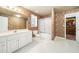 Bathroom with large vanity, toilet, textured wallpaper and tub shower combo at 1574 Stepstone Way, Lawrenceville, GA 30043