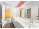 Bathroom featuring a double sink vanity with white cabinets and modern fixtures at 1574 Stepstone Way, Lawrenceville, GA 30043