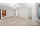 Large bedroom with neutral walls, neutral carpet, and two doorways; one to the ensuite and one to a closet at 1574 Stepstone Way, Lawrenceville, GA 30043