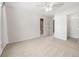 Bright bedroom with neutral carpet, ceiling fan, and ensuite bathroom and walk-in closet at 1574 Stepstone Way, Lawrenceville, GA 30043