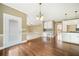 Open dining area with hardwood floors flowing into a spacious living area, filled with natural light at 1574 Stepstone Way, Lawrenceville, GA 30043