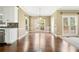 Bright dining area featuring gleaming hardwood floors, ample windows, and elegant chandelier at 1574 Stepstone Way, Lawrenceville, GA 30043